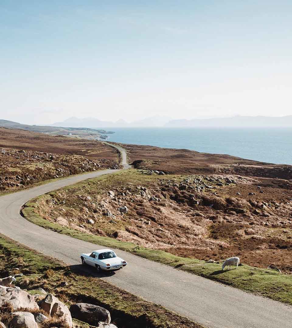 A car on a single track road on the North Coast 500