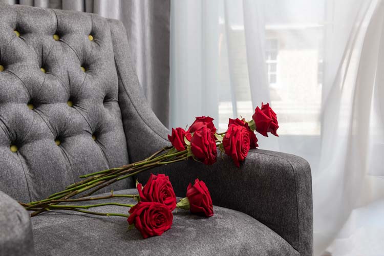 Red roses and a button back chair in a room at Ness Walk hotel in inverness