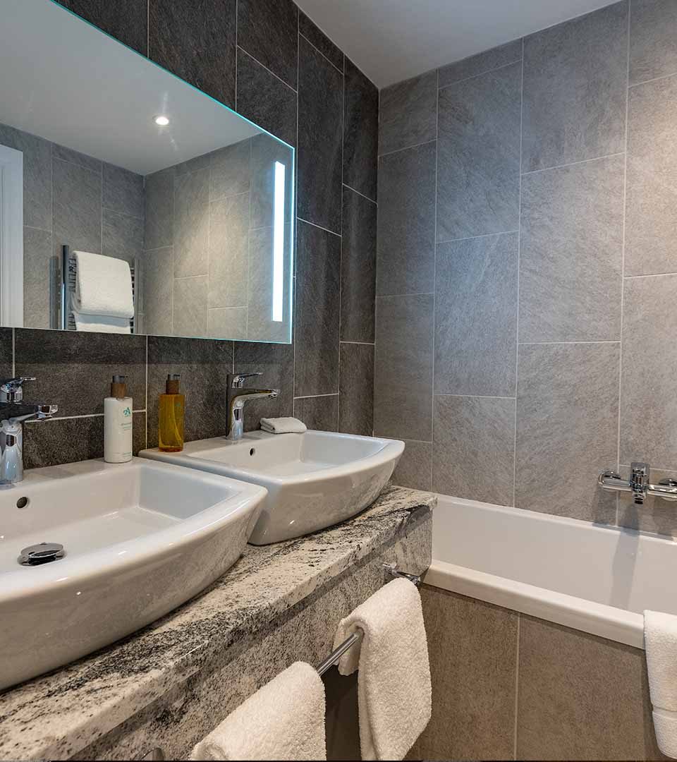 Luxury bathroom with twin sinks in a room at Ness Walk hotel in Inverness