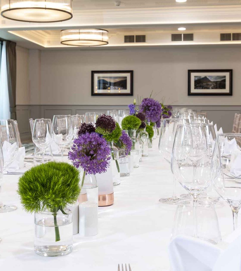 long table set for a banquet in Riverbank Room