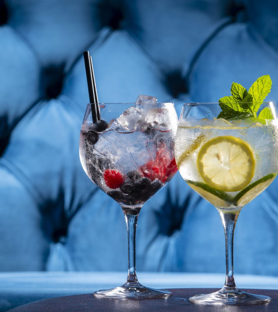 Cocktails with blue seating in background