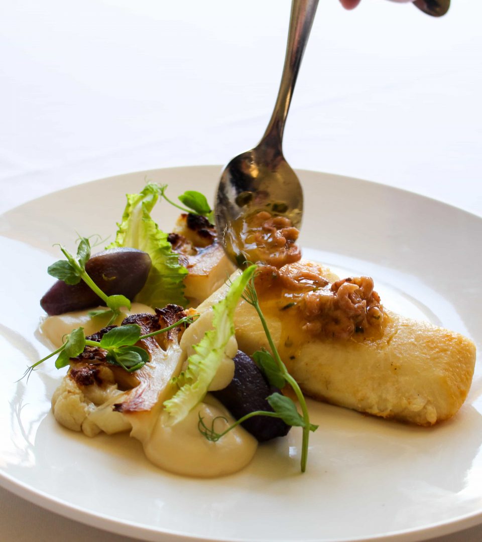 Shrimp being placed on halibut