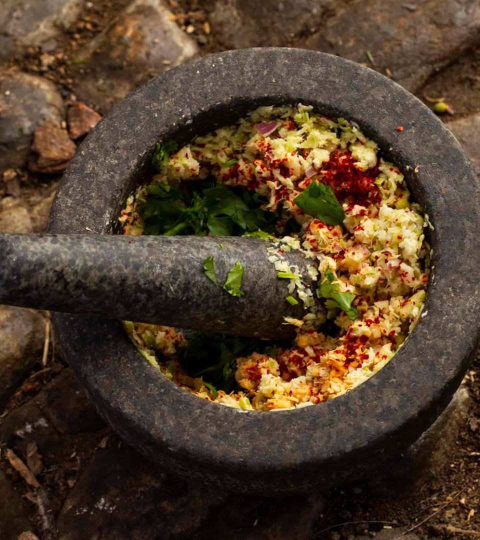 Grinding herbs and spices in a pestle and mortar