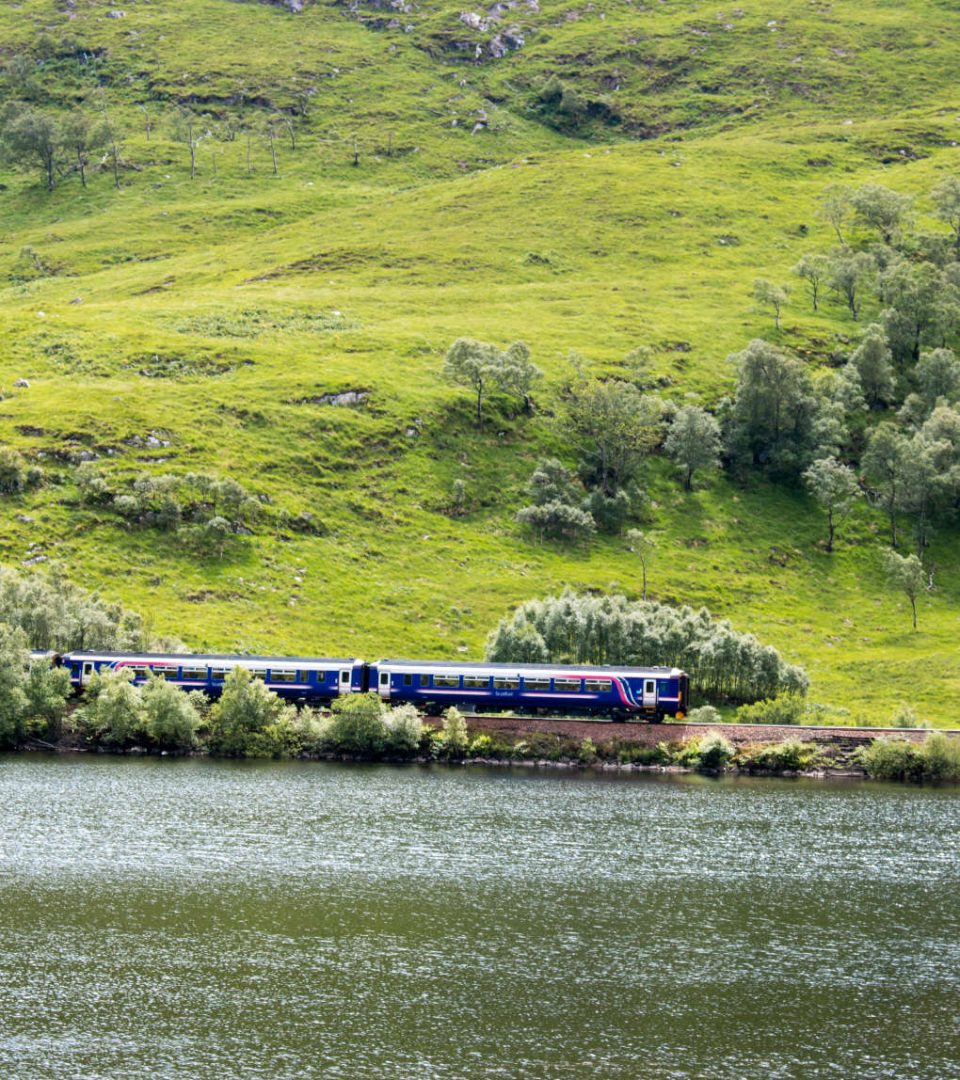 A train service travelling through Scottish countryside