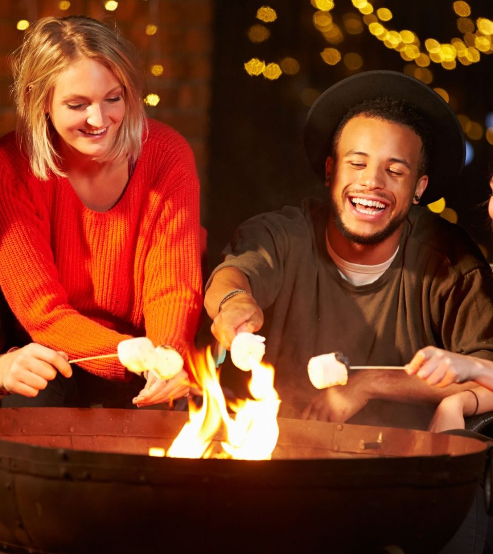 Guests gather round fire pits and enjoy a treat on the brazier