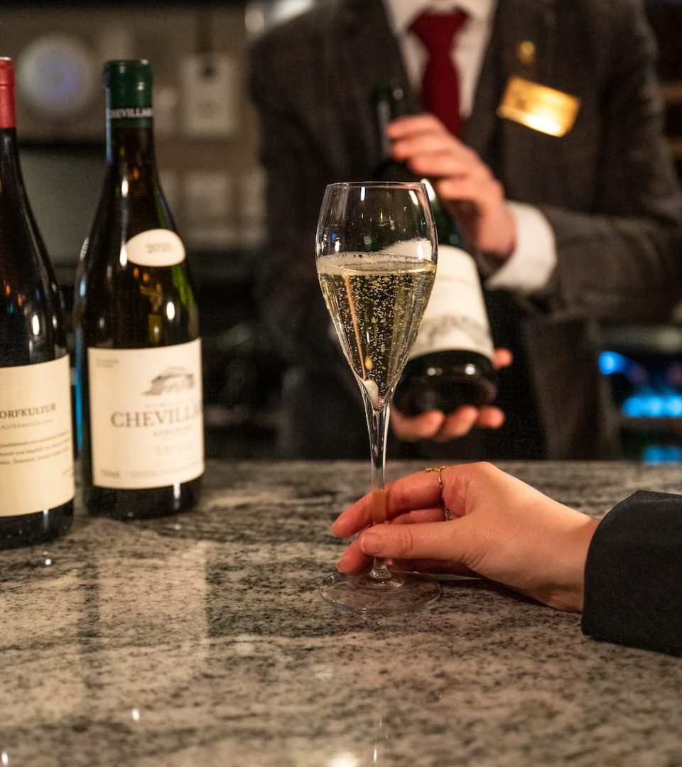 Glass of German sparkling wine during alpine wine tasting at the Ness Walk bar with sommelier