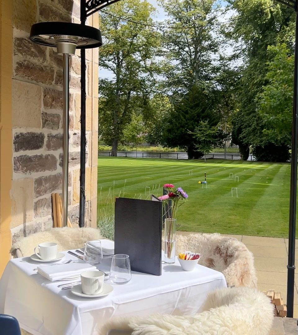 Afternoon tea outdoors with a view of the River Ness