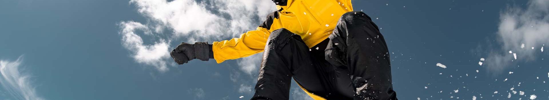 A snowboarder in yellow jacket.