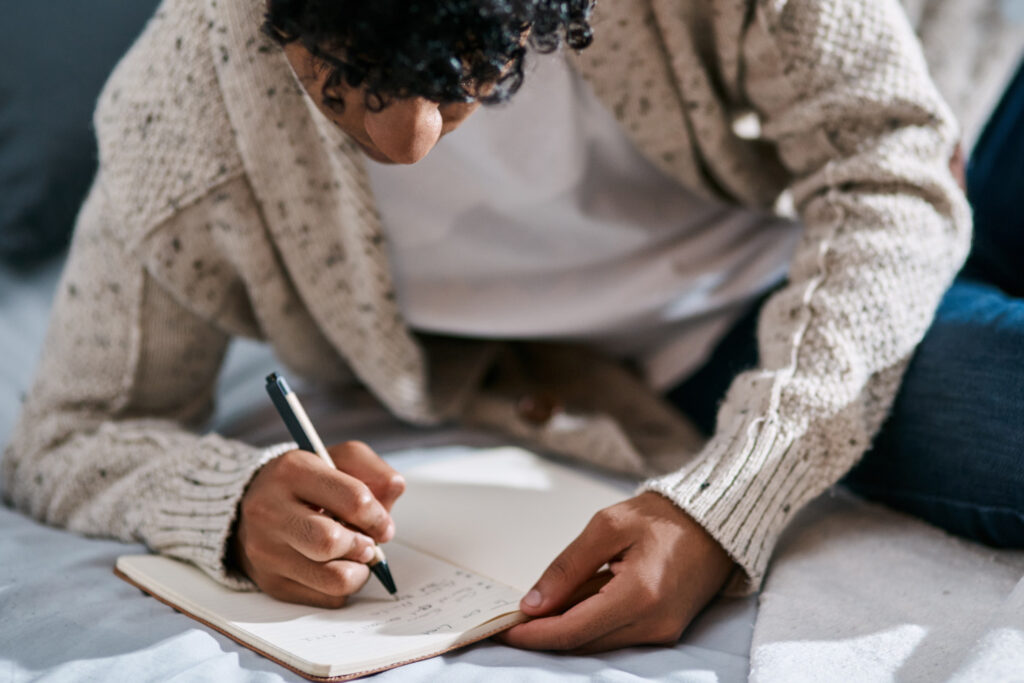 Young man writing a journal