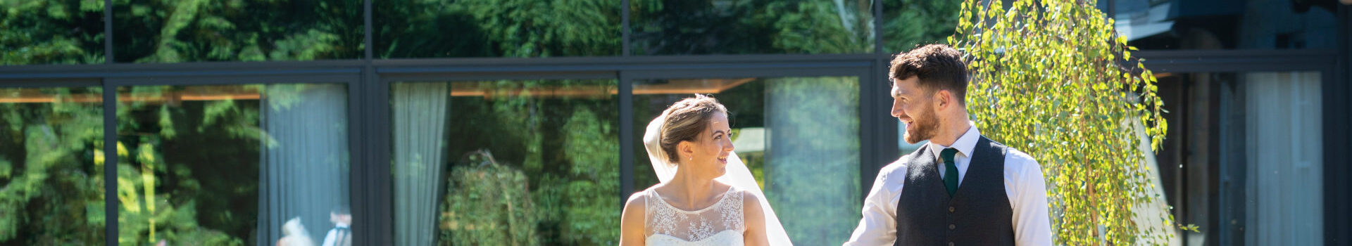 Wedding couple walking in the grounds of Ness Walk Hotel