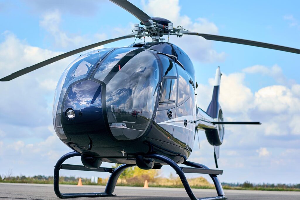 A black private helicopter waiting to take off.